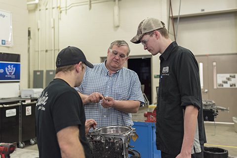 Jim Miller working in Auto lab with two students