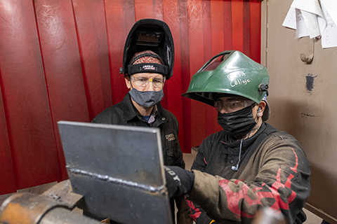 Jim Proctor in welding lab with a student