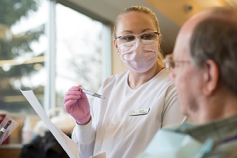 Dental student consulting a patient.