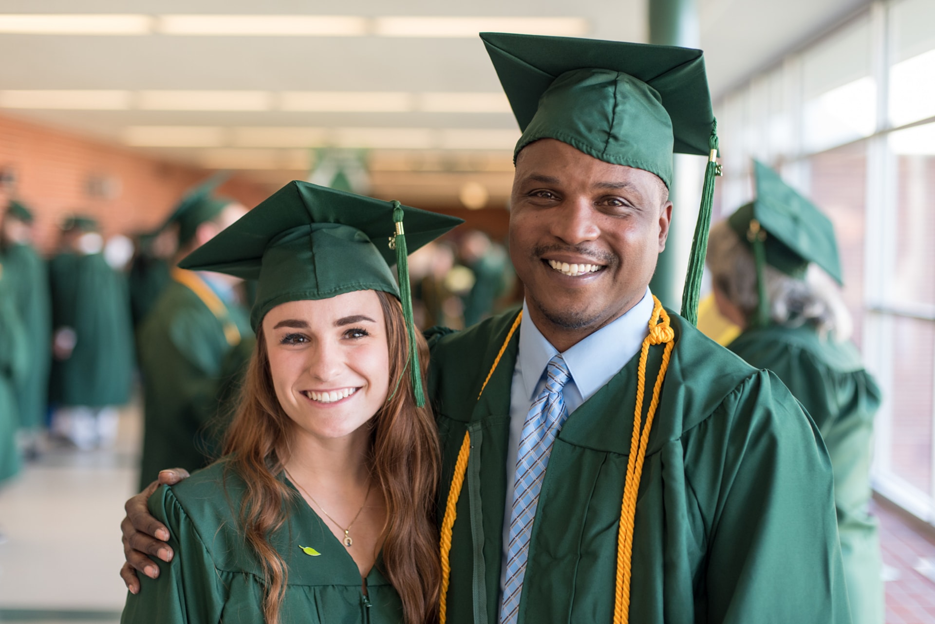 Two happy graduates at Commencement