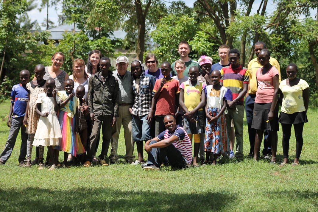 A group of Delta staff and students with villagers in Kenya